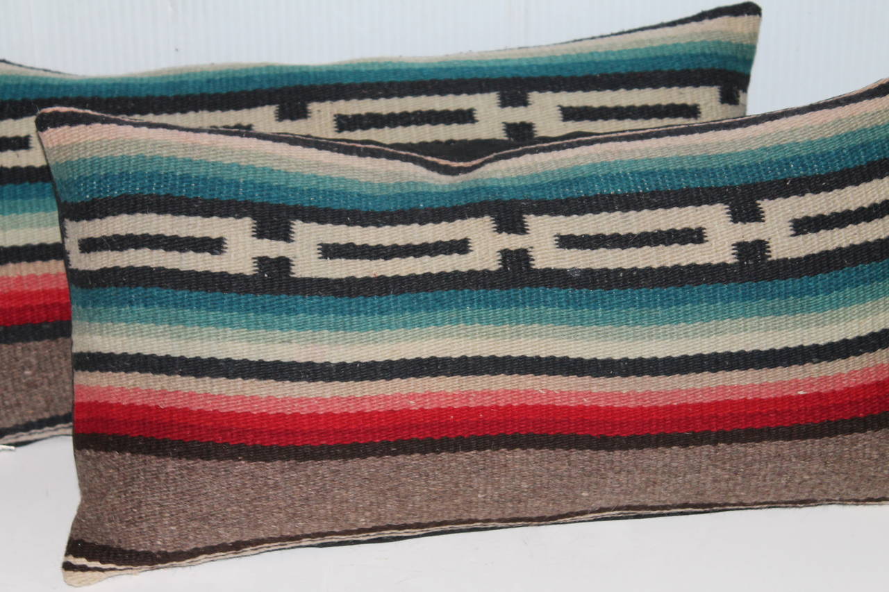 This fun and colorful pair of bolster pillows are from a serape weaving. Sold as a pair. The backing is in black cotton linen.