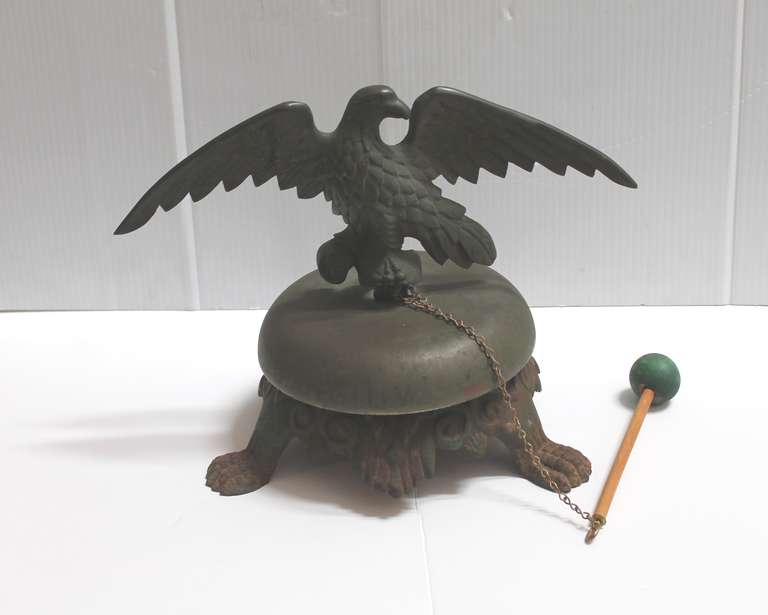 This folky 19thc  bell was probably used at a post office or some time of commercial use. It is so unusual with a wonderful bronze patina eagle on top. The bell rings beautifully with a beater  stick attached. This wonderful folk art bell has a