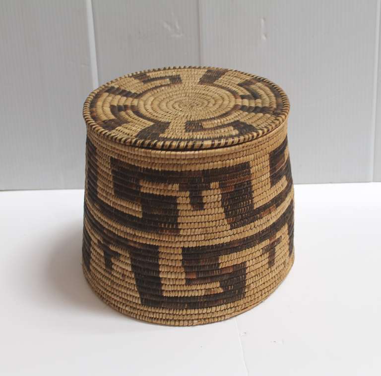 This early Papago Indian basket has geometric symbols and what looks like crosses throughout the basket. The condition is very good with the normal wear on the base consistent with age. This is a great size and cone shape form. Most unusual