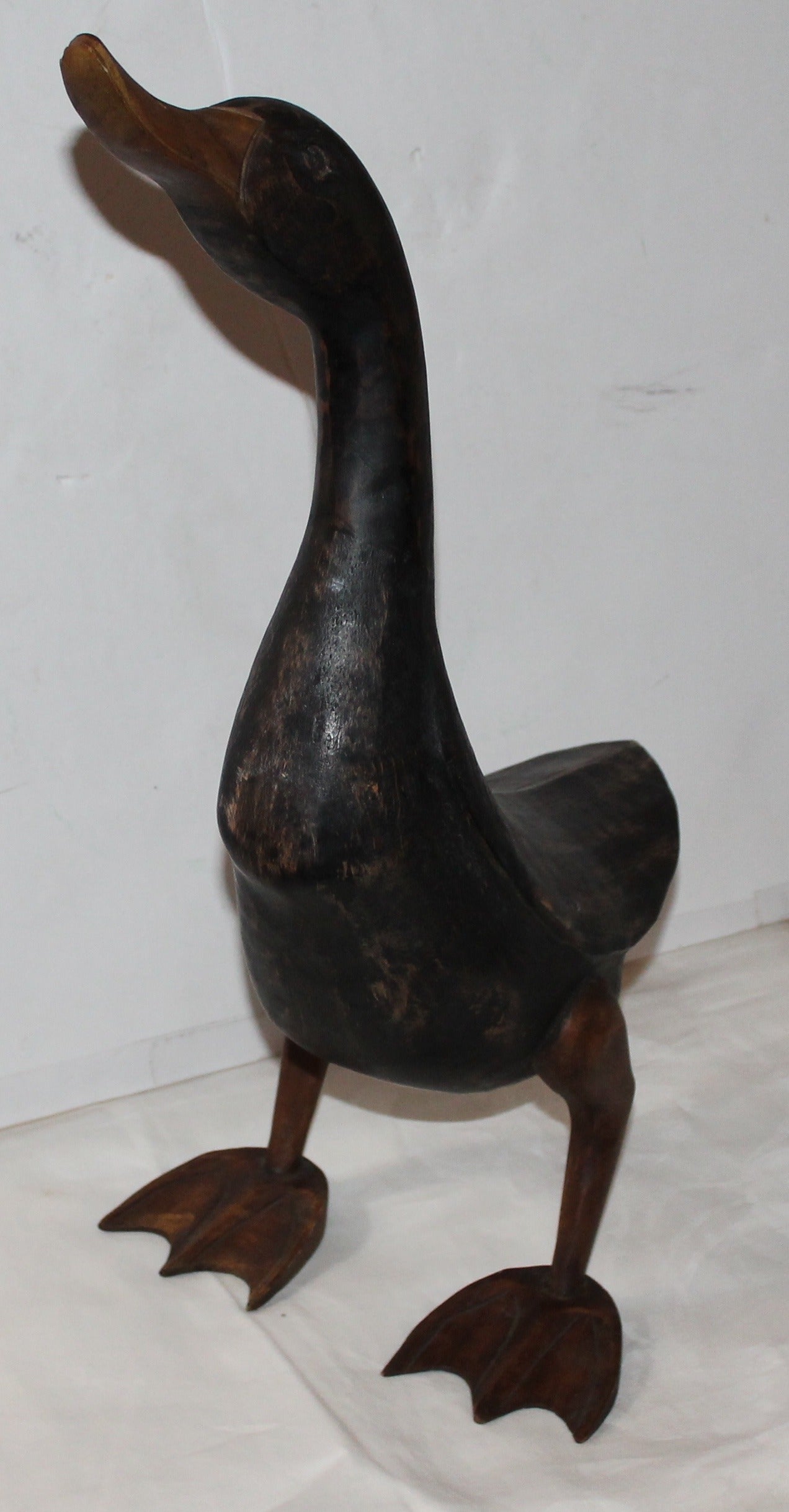 Early 20th century hand-carved and painted Folk Art funky duck. This has a wonderful painted surface black surface and mustard painted feet. The right leg has a old repair but is fine. Great piece of fun Folk Art.