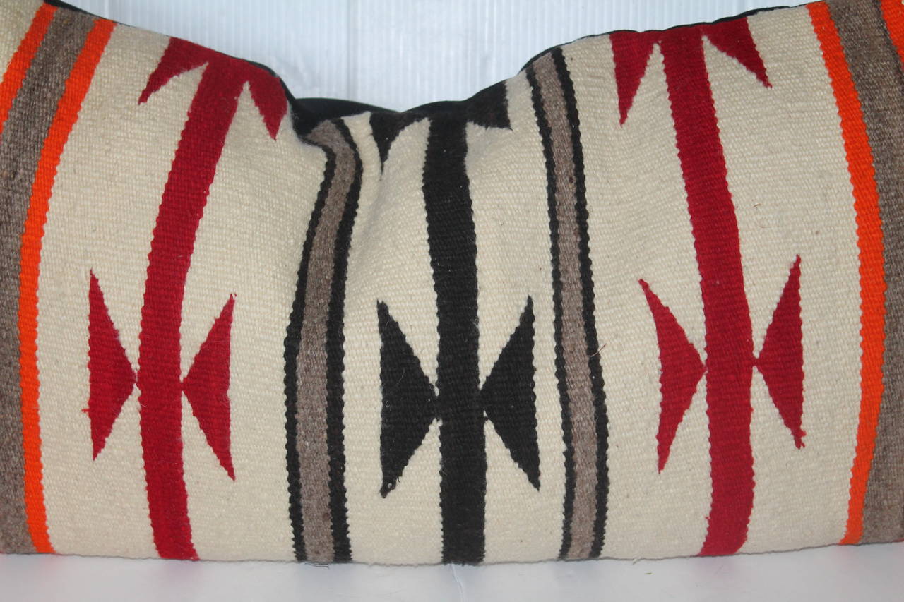 This is a very simple geometric pattern Indian weaving bolster pillow. The backing is a black cotton linen. The condition is very good.