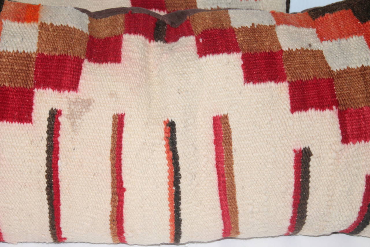 This pair of geometric block pattern Indian weaving pillows are in good condition with minor staining in small areas. The backings are in cotton linen.