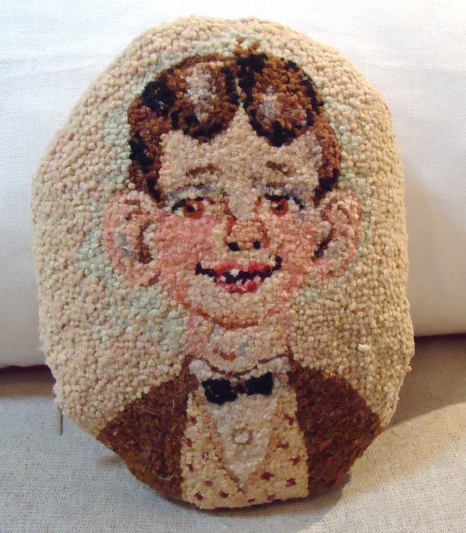 FOLKY HAND HOOKED RUG OF A FUNNY LOOKING GUY WITH OVERSIZE EARS MADE INTO A COOL PILLOW. THE BACKING IS LINEN AND DOWN & FEATHER FILLED. GREAT CONDITION.