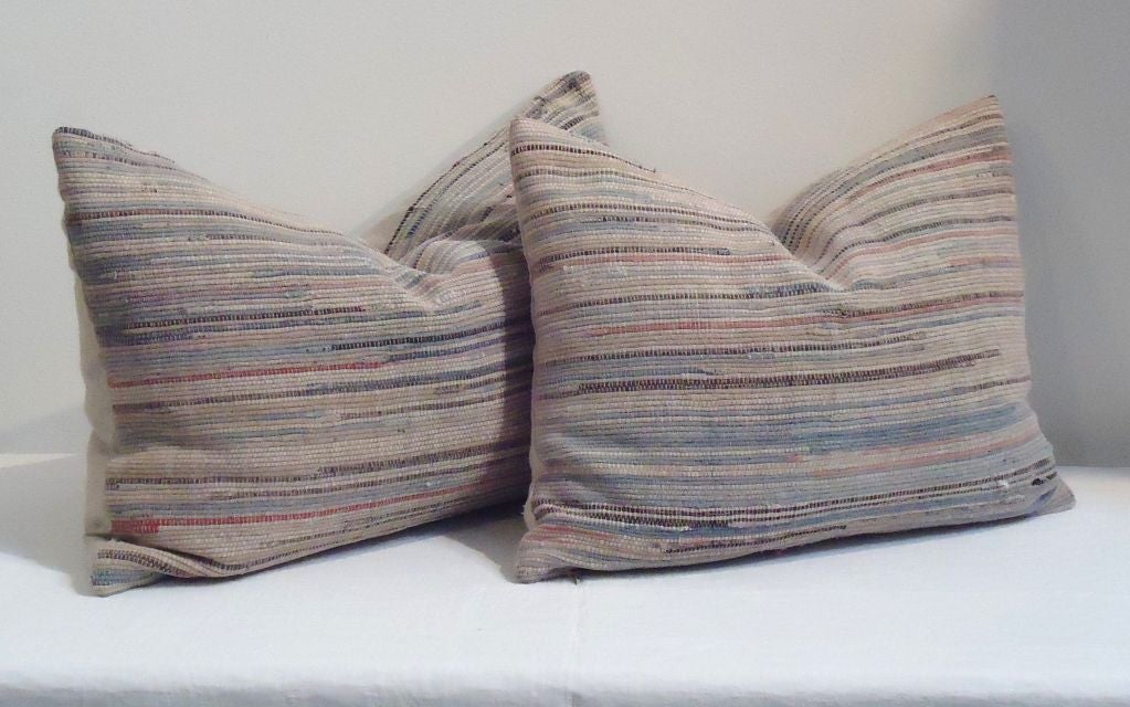 GREAT COLORS EARLY RAG RUG BOLSTER PILLOWS WITH LINEN BACKING.SOLD AS A PAIR FOR 695. IN GREAT CONDITION.