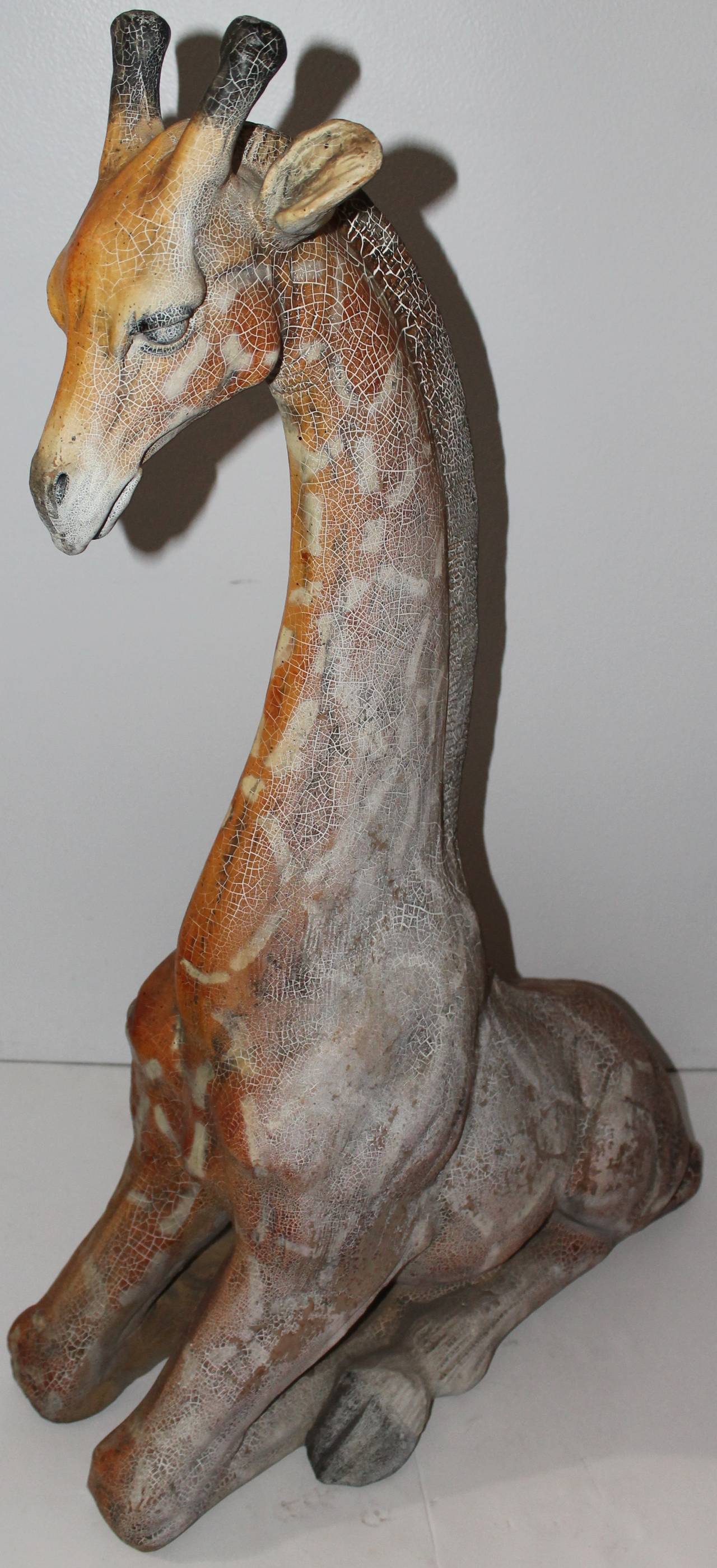 This cool folky original painted and molded giraffe. This giraffe was probably from a kiddy ride. It is made from molded resin and has a wonderful crackled, alligatored finish. The surface is the best! Onn side is totally sun faded and one side not.
