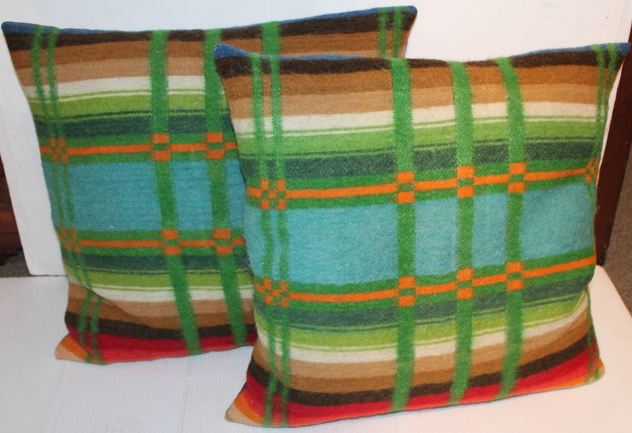 19th century horse blanket pillows.
Beautifully handmade wool horse blanket pillows that have been professionally cleaned. Mix colors green, red, tan, brown, orange, creme and blue. Pillows have minor fading consistent with age. No question that