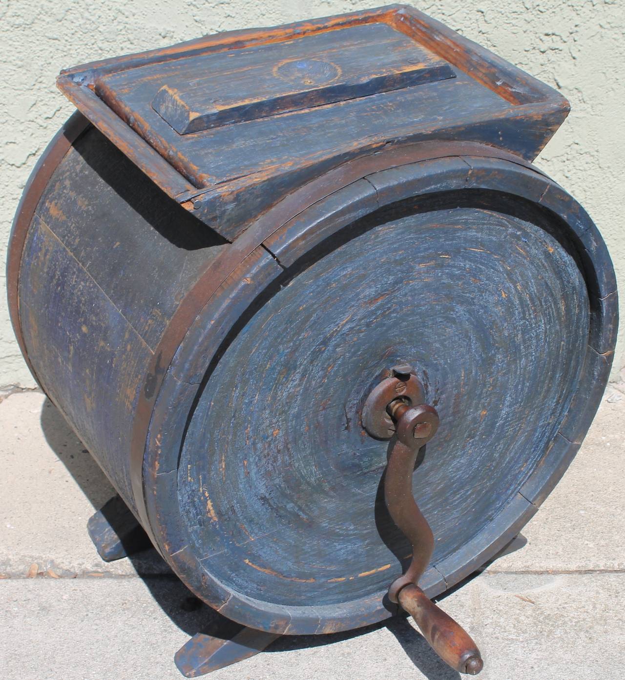 19th century original blue painted butter churn with salmon painted stencil. The cast iron crank and round bands are all original. The condition is very good and in working order. The painted surface is the very best. A wonderful worn patina.