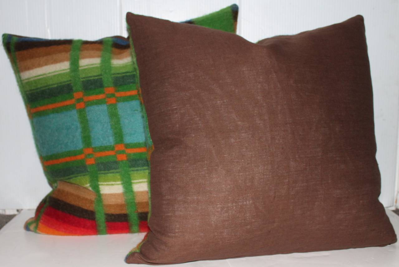 These early woven horse blanket pillows are in pristine condition and we have three pairs in stock. The backing is in brown cotton linen and down and feather filled. These are amazing colors.