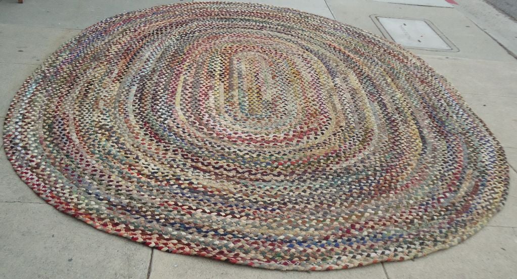 LARGE WOOL MULTI-COLORED OVAL BRAIDED RUG.THIS FANTASTIC 8 1/2 X 12 WOOL REVERSABLE RUG IS IN GREAT CONDITION.THE COLORS ARE SO MELLOW AND VERY SUDDLE.THIS FANTASSTIC BRAIDED RUG HAS EALY WOOL BLANKETS IN IT AND WONDERFUL EARLY PLAID FABRICS.