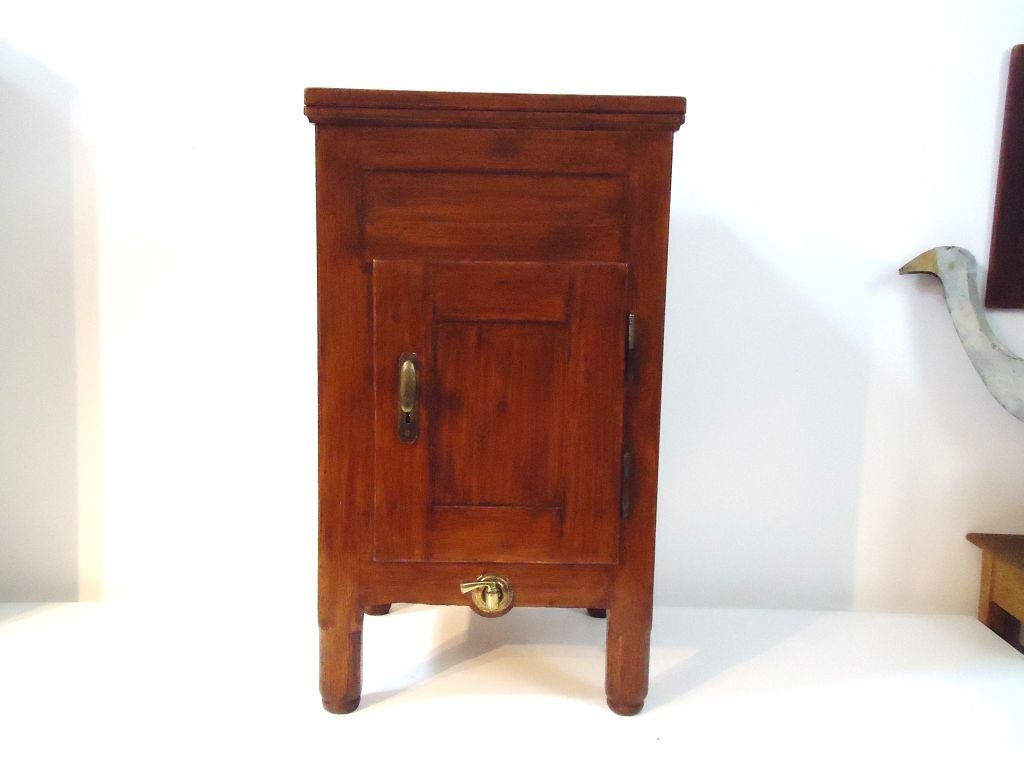 THIS VERY UNIQUE ALL ORIGINAL PINE SINGLE DOOR ICEBOX HAS ALL THE ORIGINAL BRASS HARDWARE.THIS FOLKY NARROW REFRIGERATOR IS PERFECT AS A WINE CELLAR OR BAR.IT HAS A BRASS TAP ON THE LOWER BASE AND A BRASS DOOR KNOB TO OPEN AND LOCK THE CABINET.THE