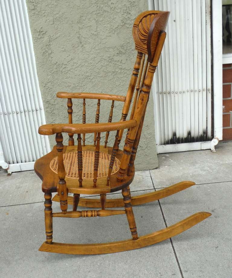old rocking chair with hole in seat