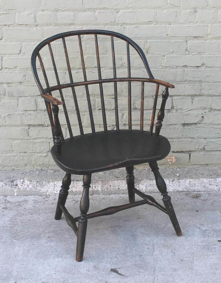This amazing 18thc extended knuckle arm Windsor chair  is in a dark original green painted surface. and in great condition. This hoop back  is signed W.S. Hilmes in pencil on the bottom of the chair. The condition is very good. The patina is the