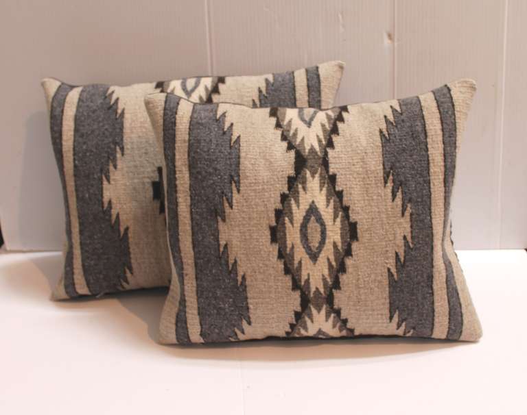 These  amazing Navajo weaving pillows with grey and black simple colors. The backing is in a grey linen backing.The inserts are down and feather fill.