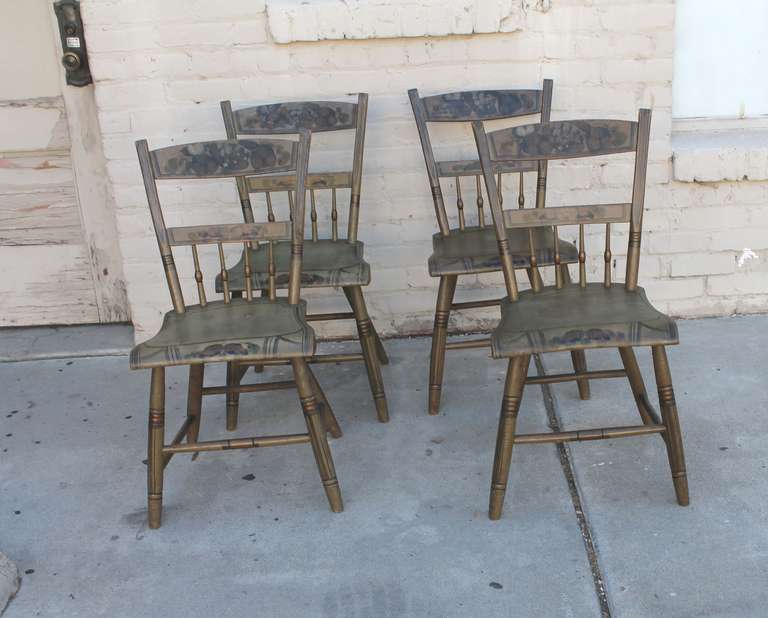 This is a very good set of four matching Pennsylvania plank bottom chairs in a wonderful original sage green painted surface. The decoration is in a taupe , grey, green and black paint.