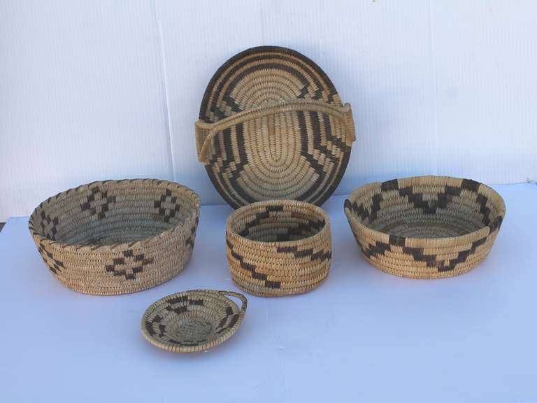 This wonderful collection of fantastic and unusual  Papago Indian baskets come from a estate in California. They are all in very good condition and all have geometric designs. Sod as a collection of five. The largest basket is 3 1/2 high x 10 deep.