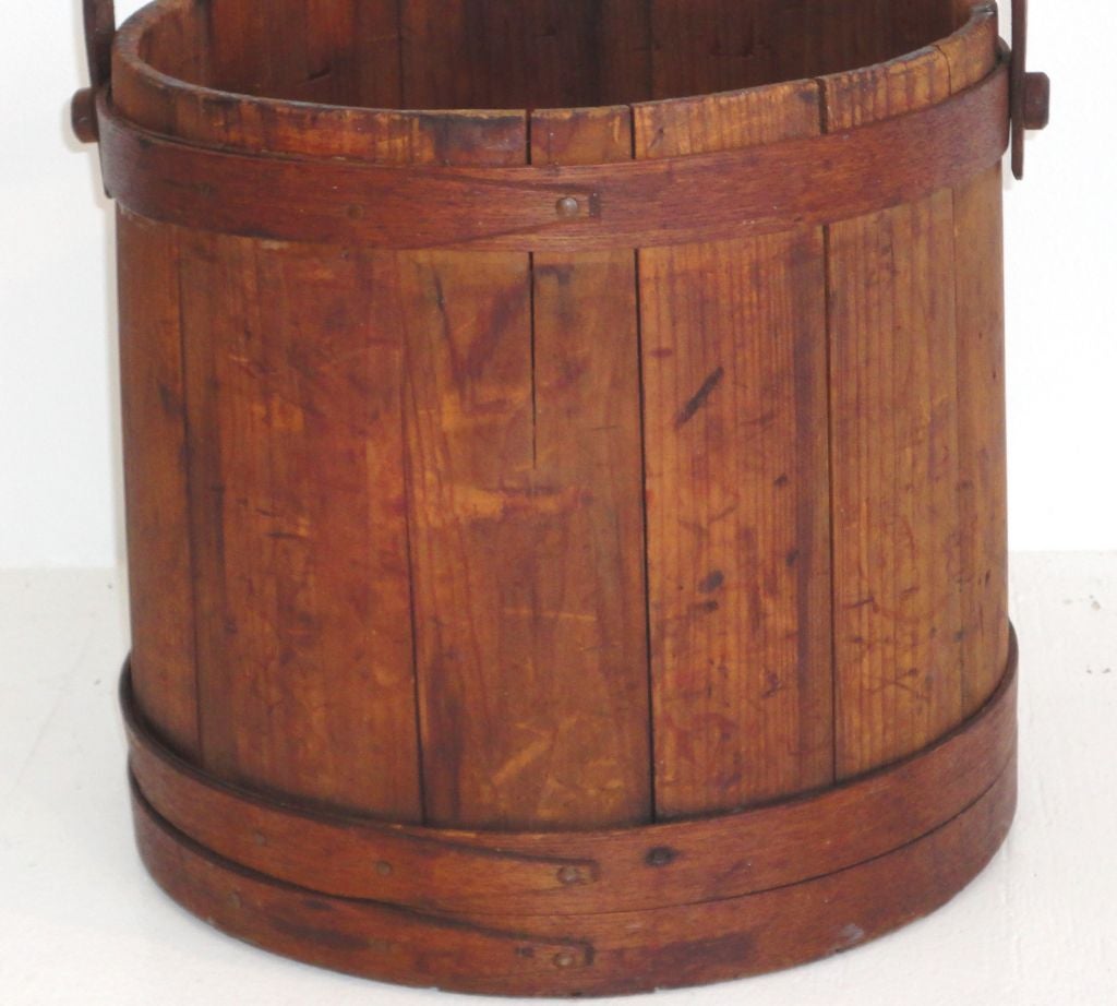 WONDERFUL DRY ATTIC SURFACE NEW ENGLAND LARGE OVERSIZE FIRKIN/BUCKET WITH SHAKER STYLE LAP BANDS AND EARLY ORIGINAL COPPER NAILS.GREAT AS A TRASH CAN OR MAGAZINE HOLDER NEXT TO A CHAIR.ALL ORIGINAL HANDLE AND PEG CONSTRUCTION.