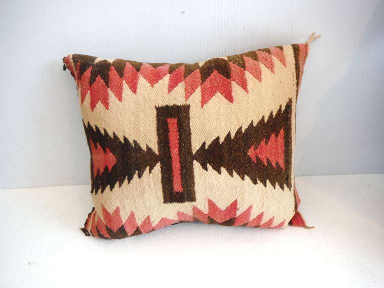 Wonderful geometric Navajo Indian weaving small saddle blanket pillow in muted colors of faded red,brown & ecru .The backing is a chocolate brown cotton linen with a down & feather insert. This wonderful geometric pattern is a diminutive size.