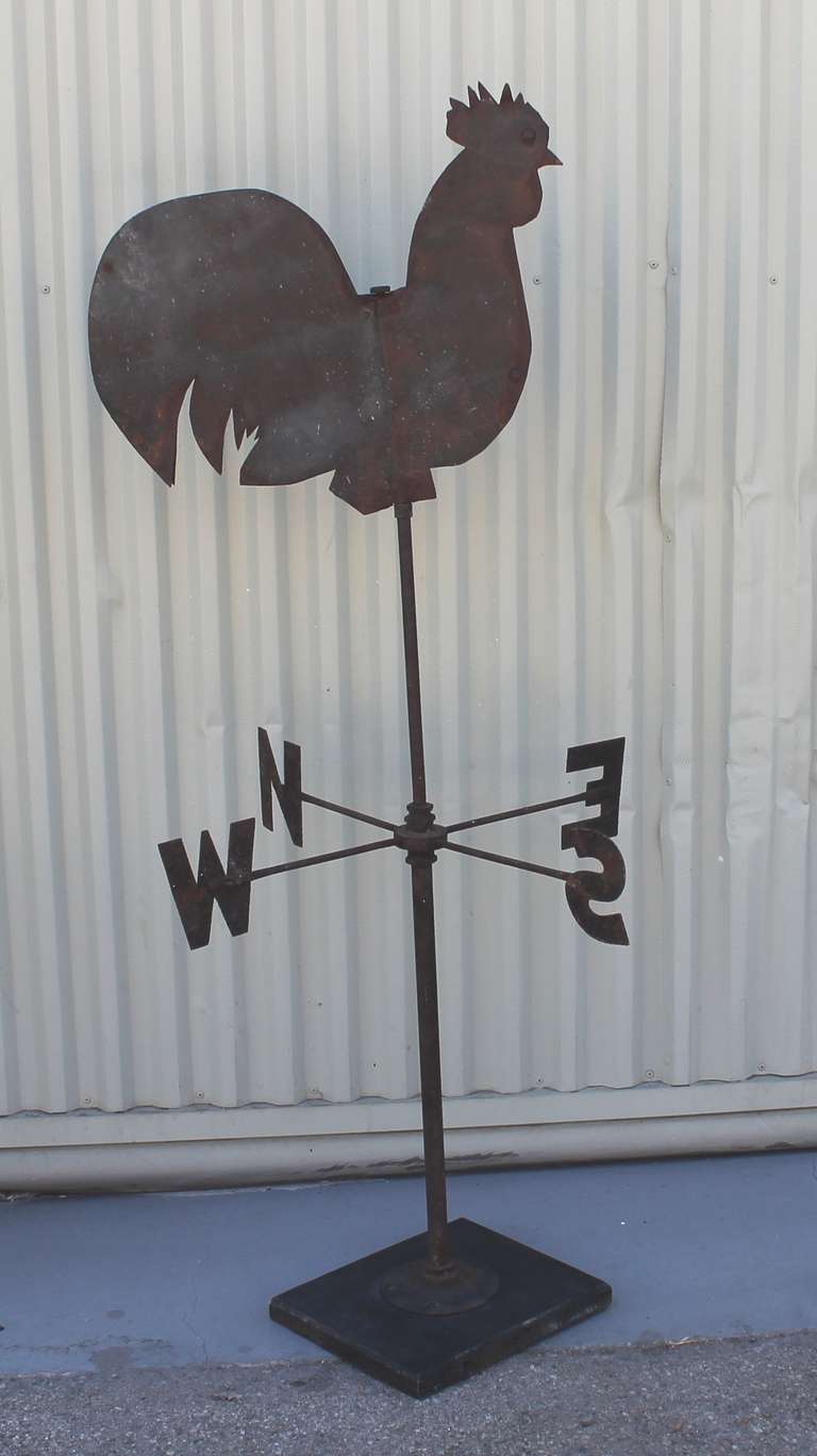 This folky rooster weather vane was found in Pennsylvania and has its original directionals. This hand made rooster is in good condition and sits on a plank of wood as found. Great folk art!