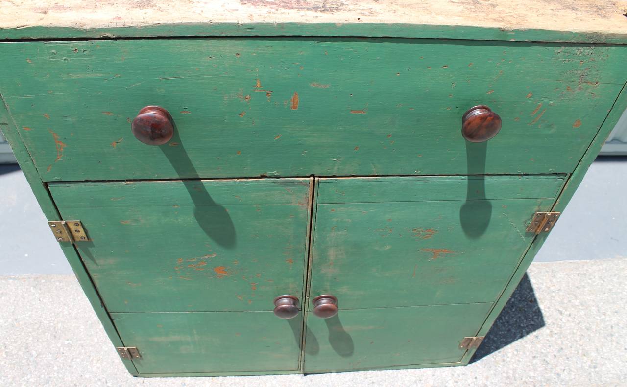 This 19th century cabinet is a collectors dream find. The knobs and paint are all original and untouched. This cabinet has wear consistent with use and age. The case is dove tail construction. It was found in Pennsylvania. The drawer is a false