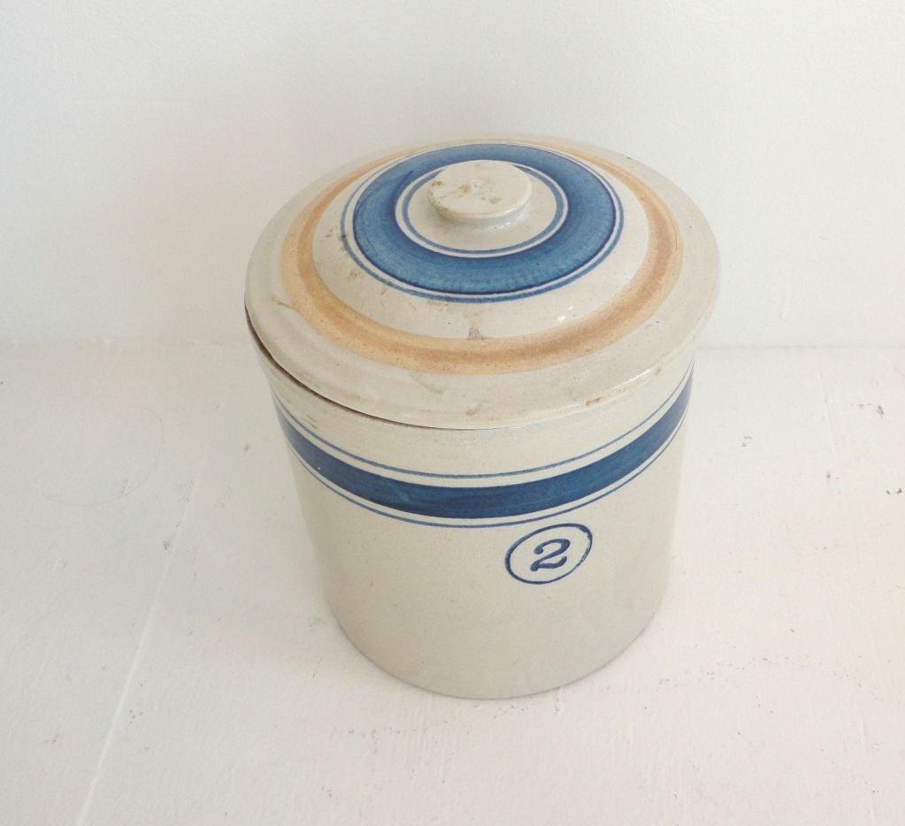 WONDERFUL MATCHING THREE PIECE CROCK/CANISTER SET WITH MATCHING BLUE STRIPED LIDS.THIS SET OF POTTERY CROCKS COME FROM THE STATE OF OHIO.SO COOL TO FIND THEM WITH THE ORIGINAL STRIPED BLUE LIDS.THE SET IS A TWO GALLON,ONE GALLON,AND A HALF