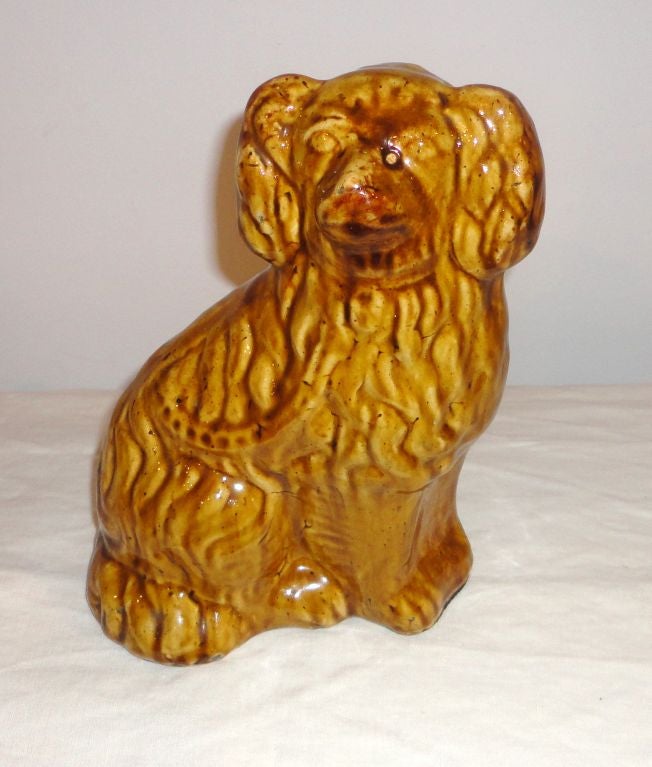 This 19th century pottery dog is in fantastic condition and these are quite rare to find in Rockingham Pottery. There are no cracks or chips. They were the state of Vermont.
 