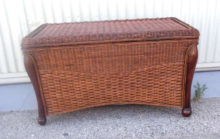 This is the most beautiful wicker trunk I have ever seen.The legs are a patined  walnut and the wicker has a great mellow old stain surface. The maker is Haywood Wakefield and looks great with rustic Old Hickory furniture or painted country