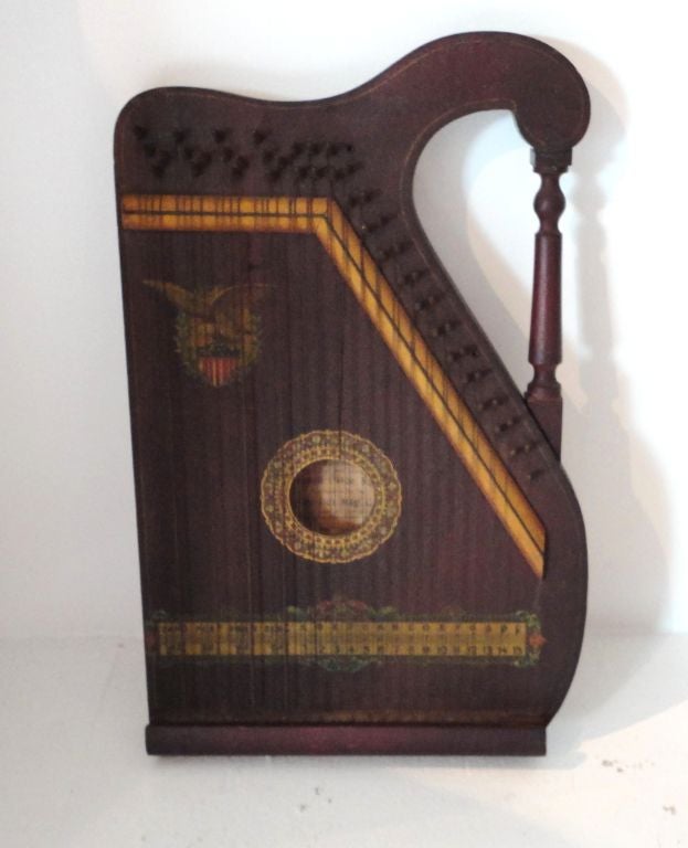 FANTASTIC ORIGINAL PAINTED SURFACE 19THC HARP.THIS PAINT DECORATED HARP HAS THE ORIGINAL OLD GILDED TRIM AND PAINTED EAGLE ON TOP OF A PAINTED RED,WHITE,BLUE AMERICAN SHIELD.THE CONDITION IS VERY GOOD AND THIS INSTRUMENT WORKS TOO.INSIDE THE