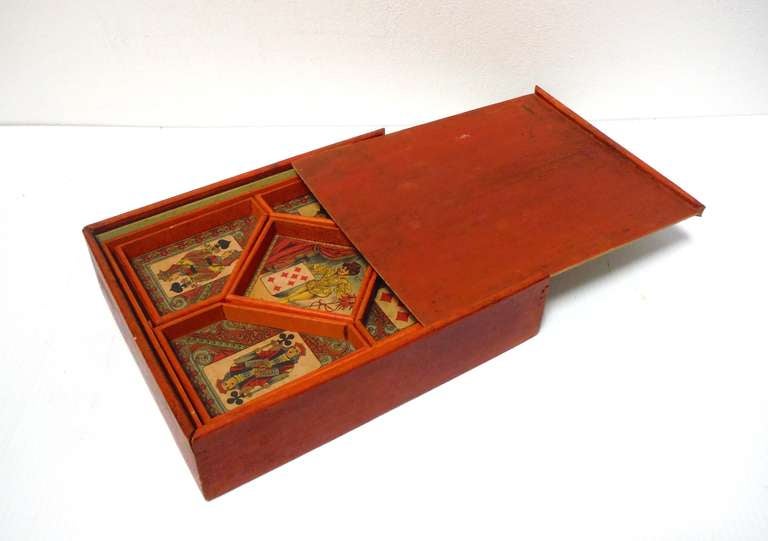 This rare find is a completely original version of the early French wagering game, Le Jeu Du Nain Jaune (Game of the Yellow Dwarf). 

In a hand constructed salmon painted wooden box, this very attractive and unique traditional French card game is