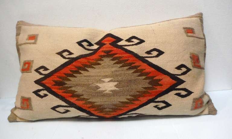 Fantastic  Navajo Indian weaving large bolster pillow with a wonderful center medallion . This wonderful folky design is most unusual with a taupe cotton linen backing . The insert is down & feather fill .