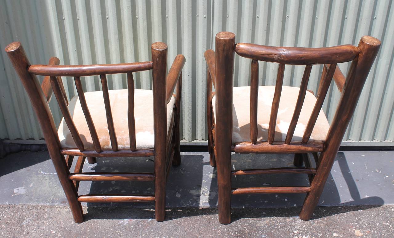 20th Century Pair of Rustic  Hickory Chairs With Cow Hide Seats