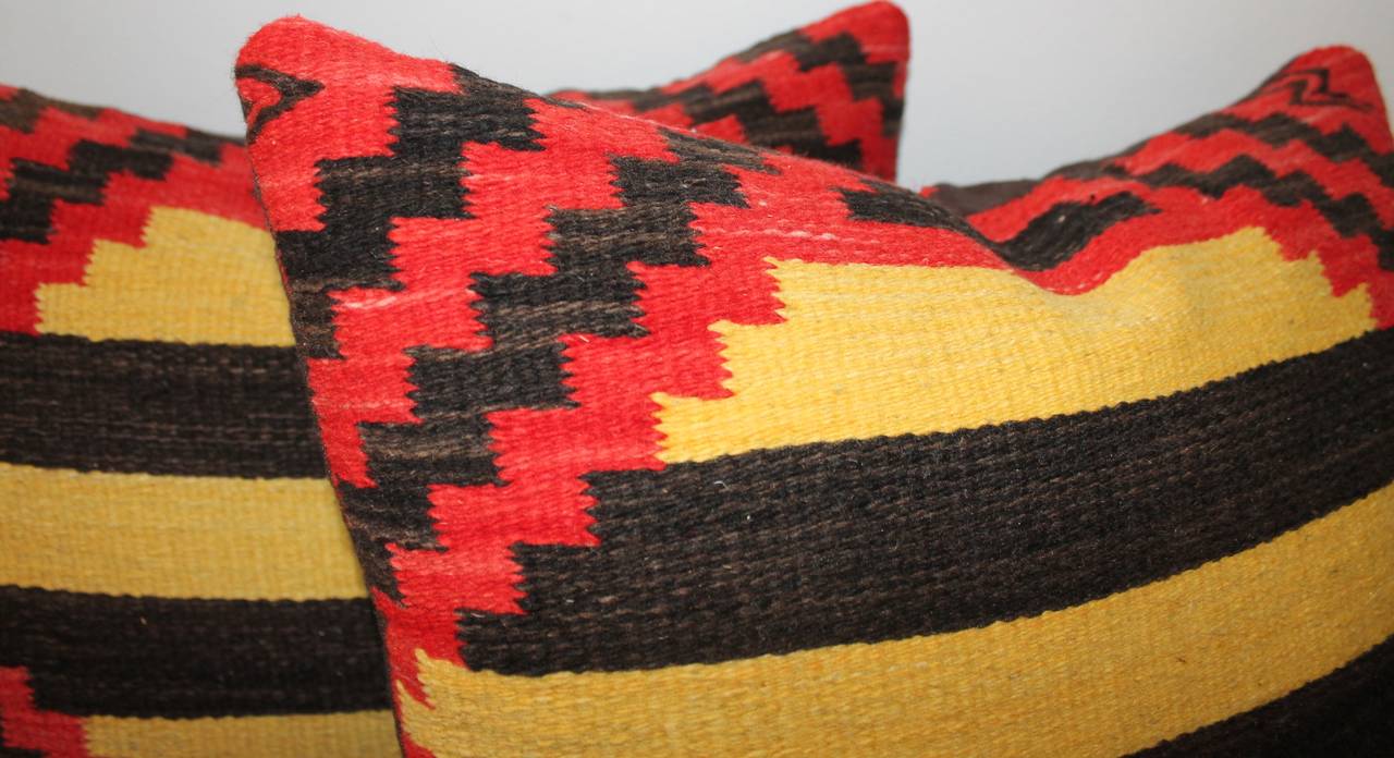 This wonderful pair of Navajo weaving pillows have a zig zag border through out the pattern of the pillow. The backing is in black cotton linen.Two pairs available in stock.