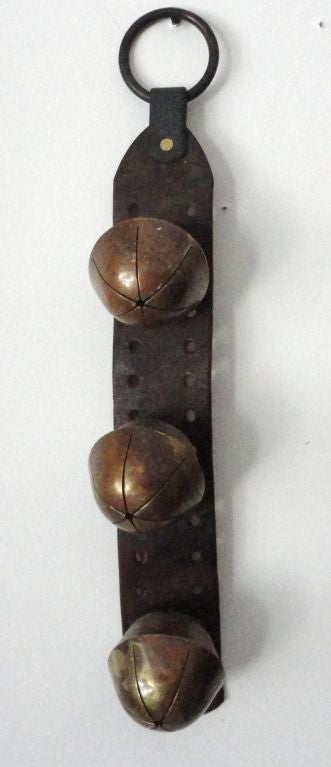 SET OF THREE LARGE BELLS ON A LEATHER STRAP GREAT FOR THE HOLIDAYS OR WONDERFUL YEAR ROUND ON A STORE FRONT DOOR .THE SOUND IS GREAT AS THEY OPEN THE DOOR AND LETS YOU KNOW SOMEONE IS THERE.GREAT ORIGINAL CONDITION.