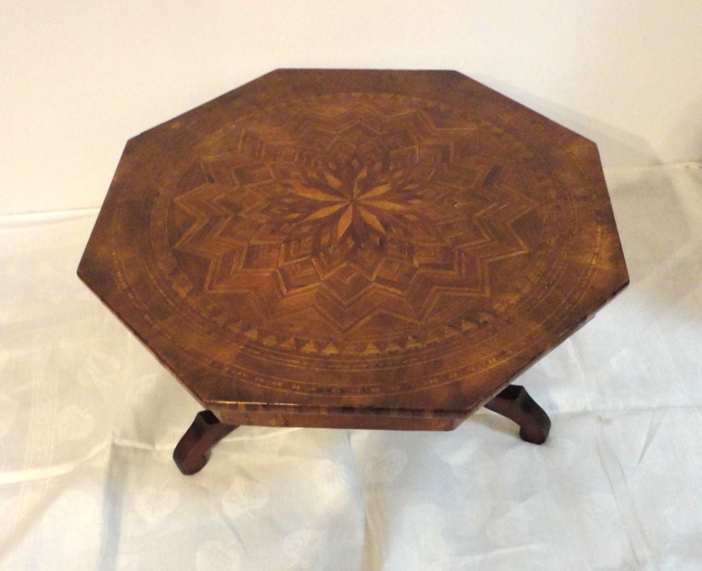 FOLKY HANDMADE 19THC STAR VARIATION INLAID WALNUT COCKTAIL TABLE.THIS TABLE RESEMBLES A QUILT PATTERN AND IS SO WELL CRAFTED ,WITH GREAT DETAIL WORK TO THE STAR PATTERNED TOP.THIS TYPE OF CRAFT WAS DONE QUITE FREQUENTLY WITH THE SAILORS WHEN THEY
