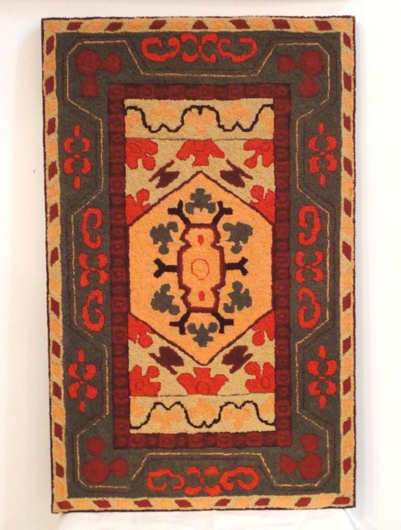 Wonderful variations of PA. Dutch colors and typical of Lancaster Co. colors. Super geometric hand-hooked rug sewn on linen stretcher frame. The colors of salmon, orange, tan and greens. Great wall art. The condition is mint.
 