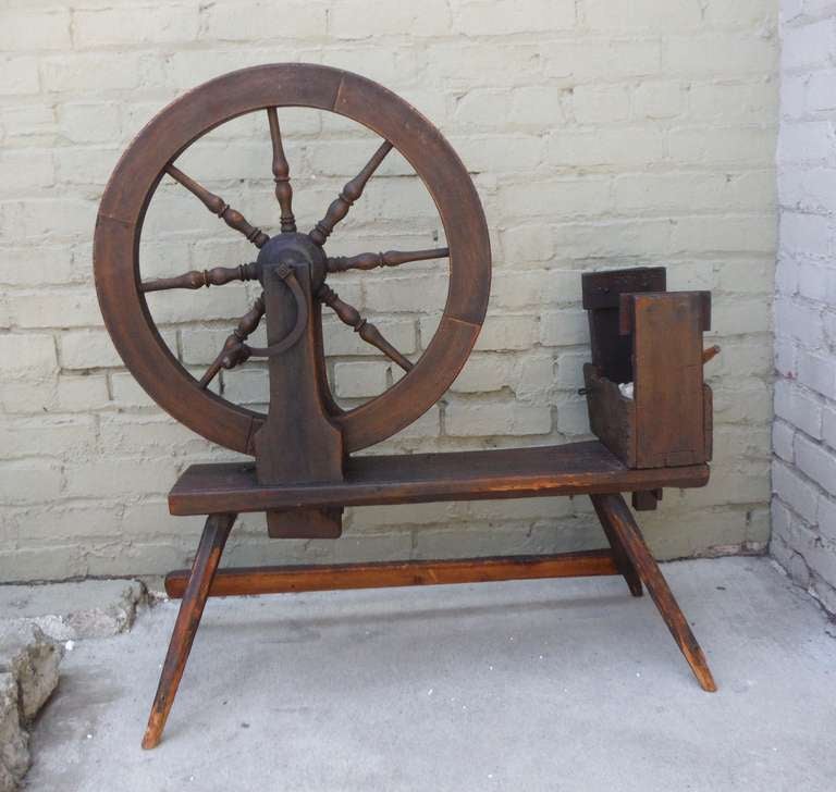 Amazing early 18th century old surface handmade and hand-forged construction. This wonderful spinning wheel has the original lamb’s wool box for the flax and great scalloped details and cut-out. Everything is original to this piece. All iron work is