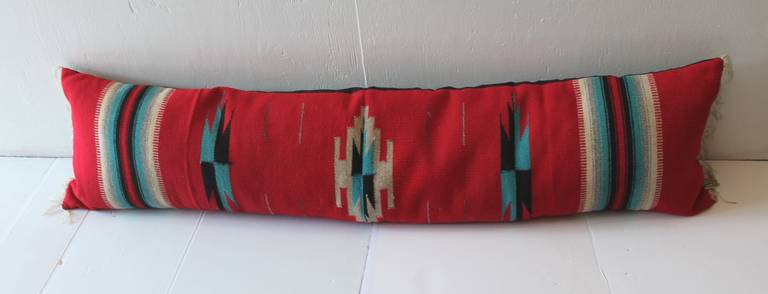Large red handwoven serape headboard bolster pillow. The backing is in black cotton linen. The insert is down and feather fill. Wonderful statement!