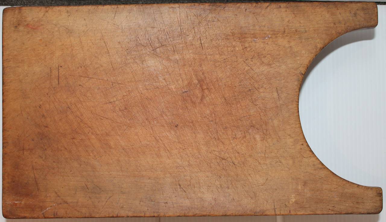 This fun cutting board has cool cut-out legs and is reinforced with old antique screws to keep it tight. Condition is very good and sturdy. Great for cutting veggies or meat. Wonderful patina! This was found in Pennsylvania.