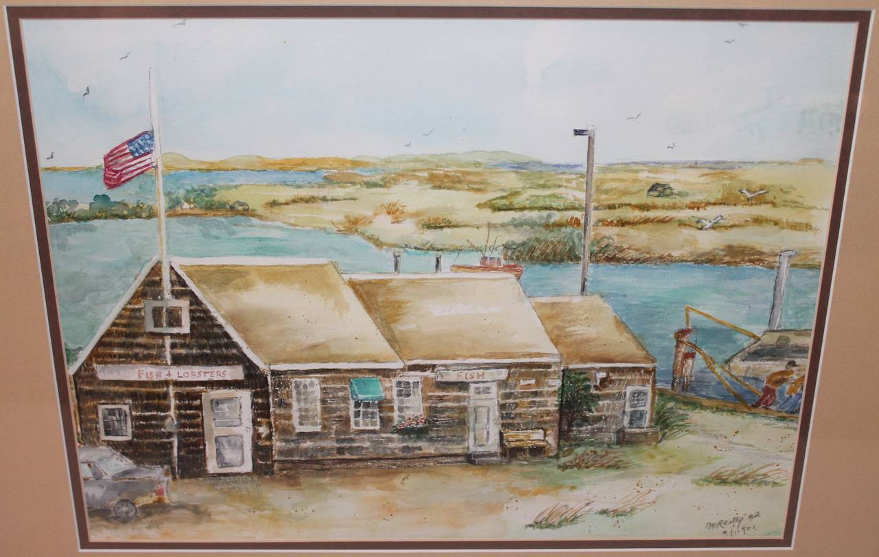 This wonderful folky watercolor is done off the coast of Maine and depicts a fish and lobster restaurant. Cool folky painted American flag over top of the building. This painting is signed M. Redly 9/11/01. The condition is pristine. Newly framed