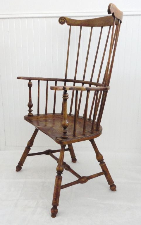 EARLY 19THC ORIGINAL MUSTARD PAINTED EXTENDED ARM FAN BACK WINDSOR CHAIR IN WONDERFUL SURFACE.THIS FINE PATINA HAS A RED BASE WASH COAT WITH WORN EXTENDED ARMS .THE TURNINGS ARE SO FANTASTIC AND GREAT SPLAY TO THE LEGS.THE SADDLE SEAT HAS WONDERFUL