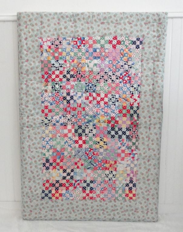 Wonderful mini pieced postage stamp crib quilt in a mix of feed sack material and old dress prints. This folky and fun quilt has quarter inch squares all wonderful executed together in variety of colors. Found in central PA and is in pristine