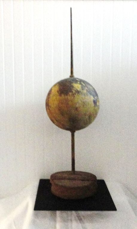 Fantastic folky oversized 19th century mustard over copper Lightning rod ball on a professional iron stand. The base is a plank of original work that the rod was placed in when made. This is so rare to see this big of a Lightning rod that is not