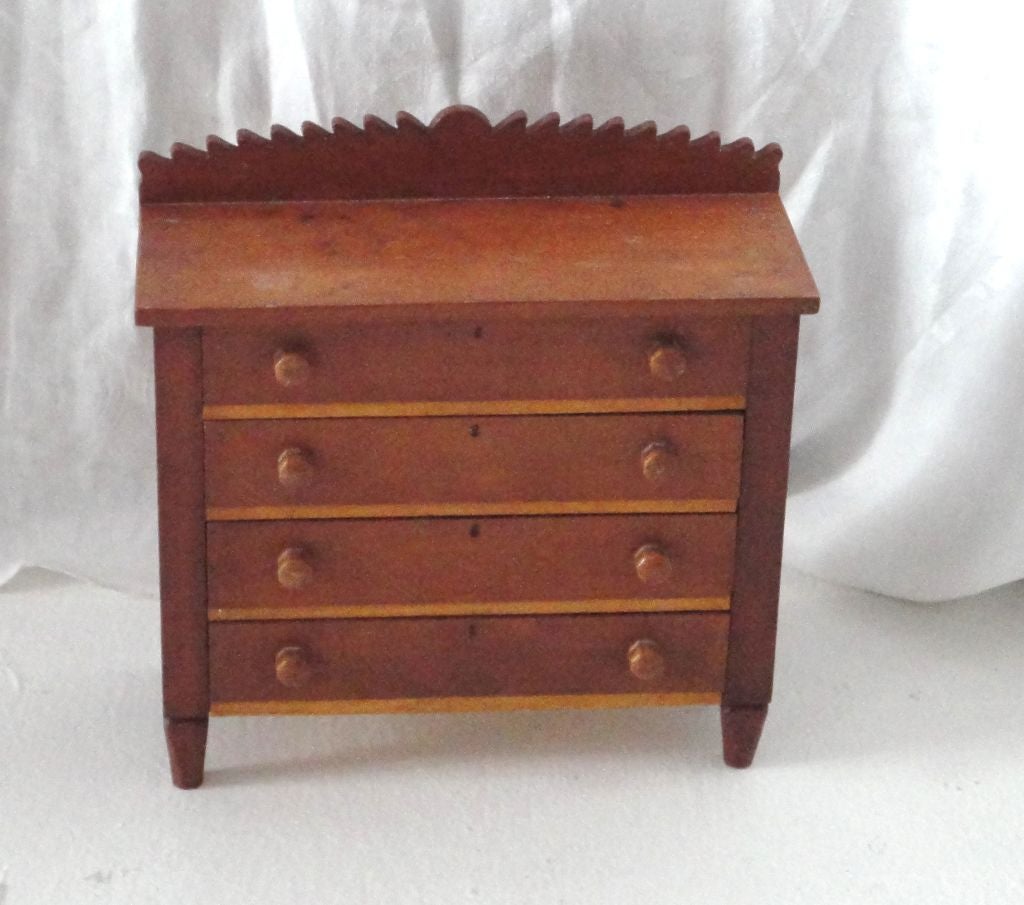 Fantastic early miniature chest of drawers with a painted key hole.This little fantastic handmade chest of drawers is probably a salesman sample of which this design was made later in a larger piece of furniture .This is a great piece of miniature