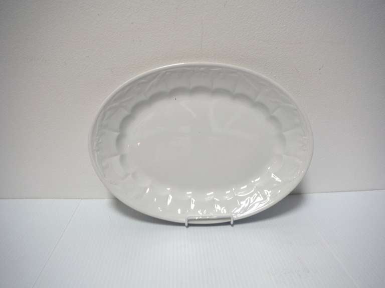 This early 19th century and mint condition wheat patterned trimmed platter is snow white and marked England Pearl Ironstone China, Turner & Tomkinson on the reverse. The pattern is fruit and wheat vines.