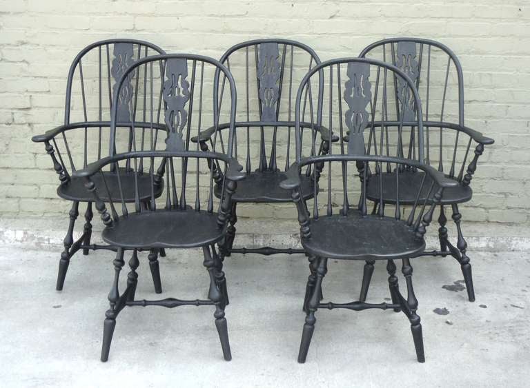 Fantastic set of five matching black painted 19thc brace back extended arm Windsor chairs from New England .This set of five strong and comfortable extended arm Windsors are in great condition with a over painted grungy surface . This is so rare to