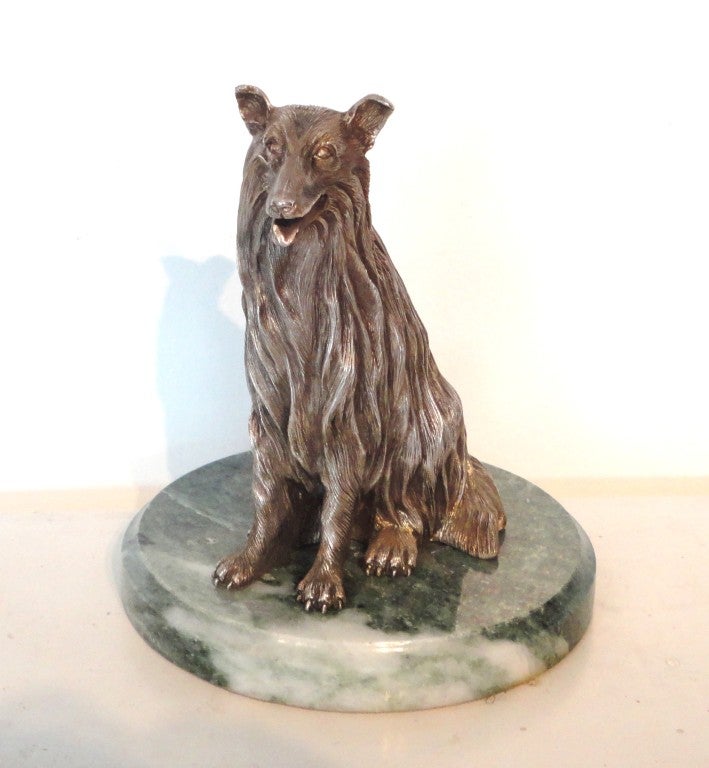 Fantastic sterling silver statue of a dog sitting on a green marble base.This silver dog is stamped 925 on the base and the original sticker from the art gallery is on the base. It reads : MADE WITH PRIDE IN USA 