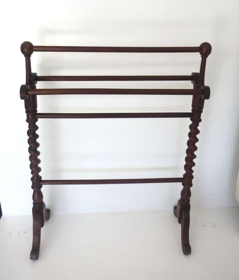 Walnut quilt rack with barley twist ends,  hand-carved supports and five horizontal dowels.  This 19th. century rack is in excellent condition and particularly decorative for a functional piece of this nature.