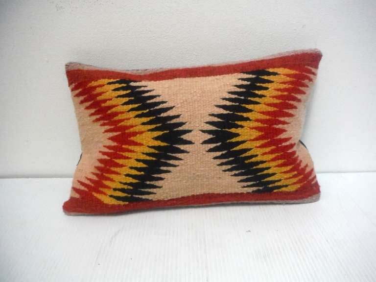 Fantastic Navajo weaving from a saddle blanket made into a pillow. The backing is black cotton linen .