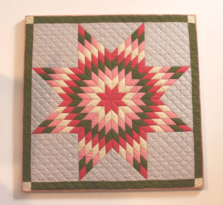 This is a wonderful and vibrant Pennsylvania eight point star crib quilt. The piecework and quilting is a number one. This quilt has been professionally laundered and sewn on linen and mounted on a wood stretcher frame. This crib quilt is 47inches