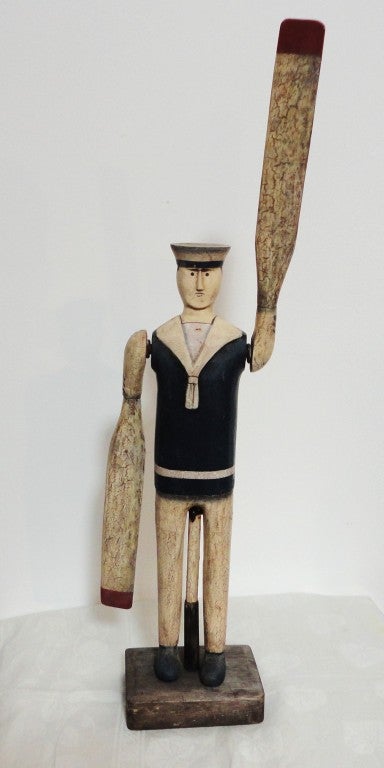 This handmade & painted folky sailor whirligig on the original wood stand that was made for it.Yes it is late but very great !There is missing paint in the center stem and under arms , but all in good working order.The arms spin around as they
