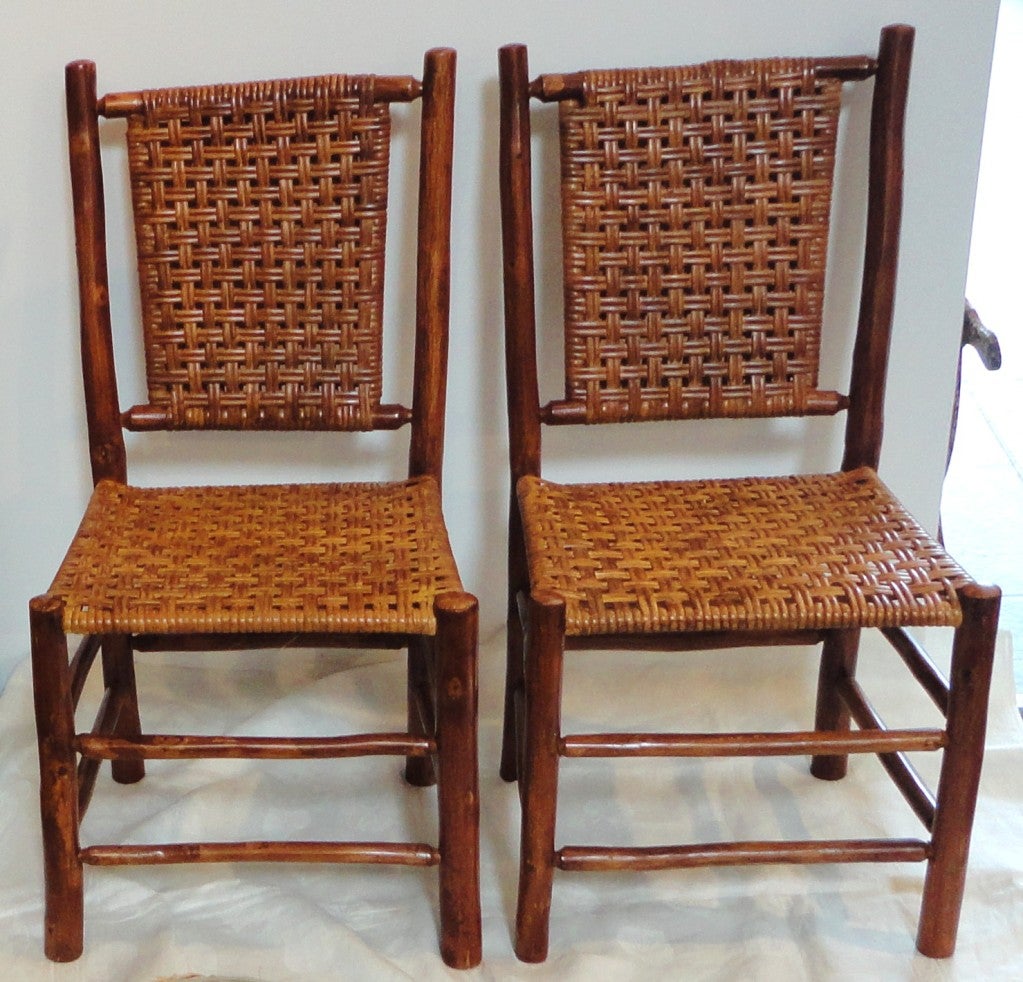 This wonderful pair of Old Hickory side chairs are in wonderful condition and have a great old original stain & varnish finish.This pair of side chairs have the original brass numbered tag on the bottom of each chair. This is the number from the